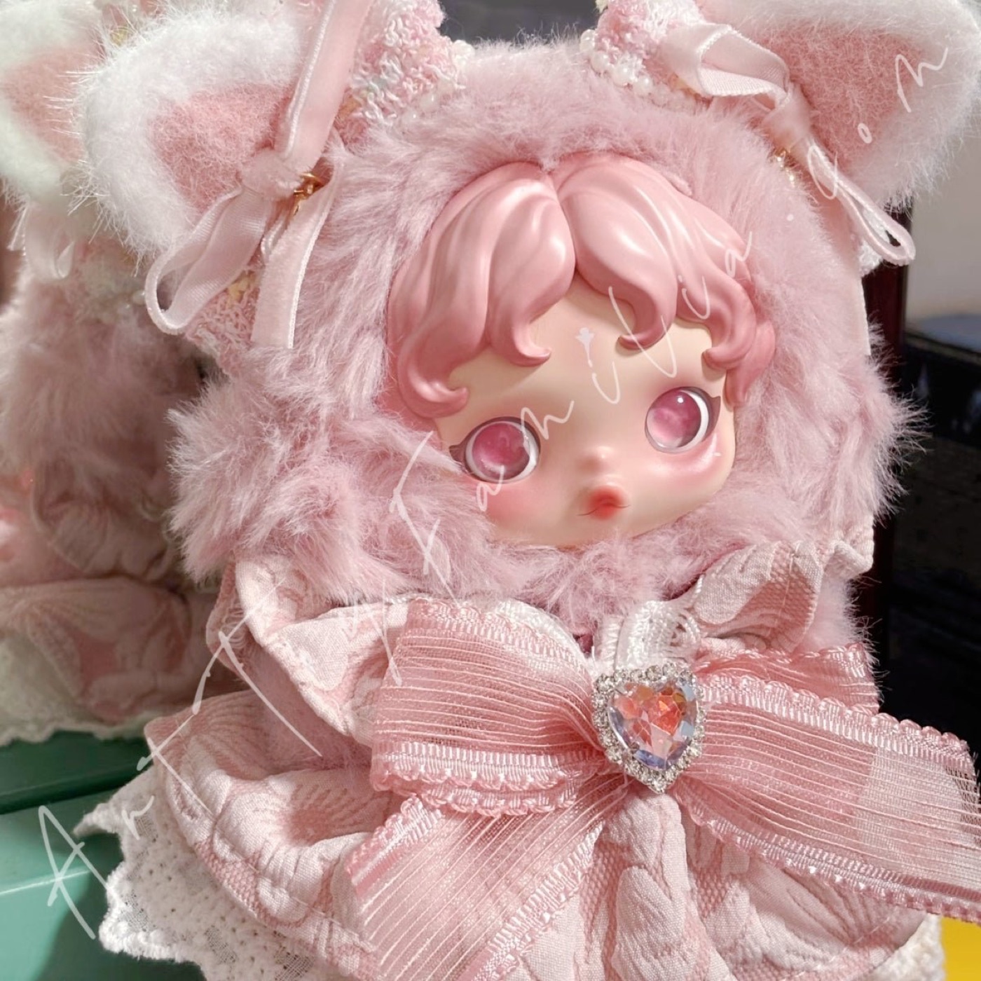 Pink clothing and accessories styled on collectible figures